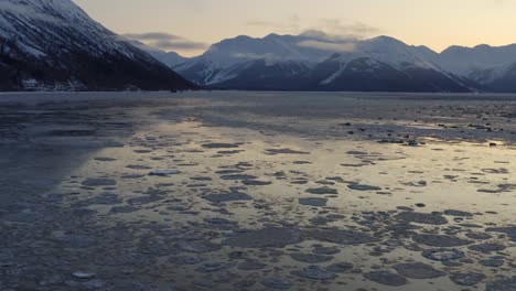 Stunning-landscape-of-Alaska-with-icy-water-and-impressive-mountain-range,-drone