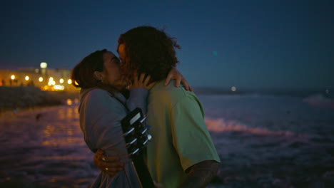 passionate teenagers kissing evening shoreline close up. couple romantic date