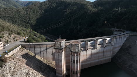 aerial view rising over sau reservoir concrete hydroelectric dam structure in green woodland valley