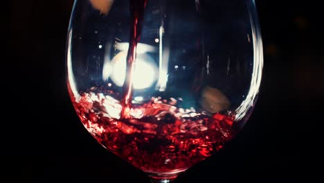 red wine pouring into glass