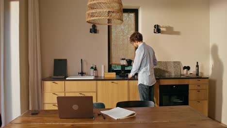 man working from home in a modern kitchen