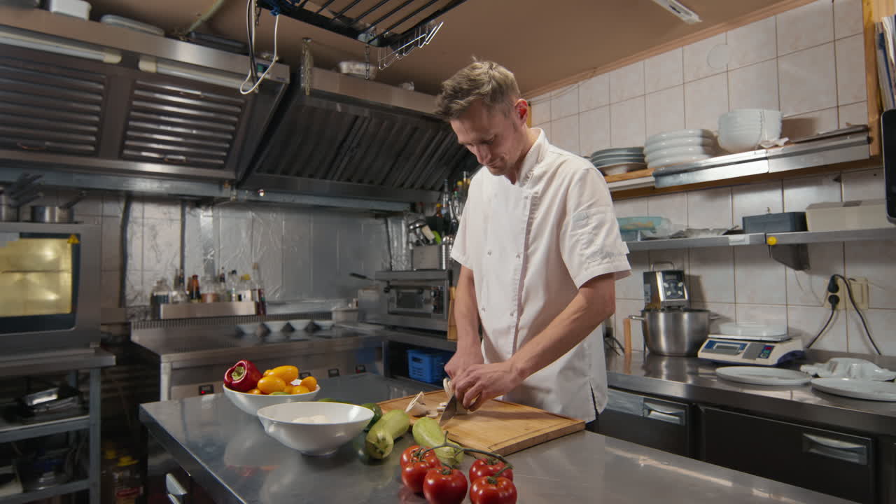 Chef Slicing Mushrooms At Restaurant Kitchen