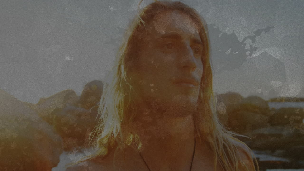 Standing by rocky shoreline, long-haired person enjoying soft sunlight outdoors