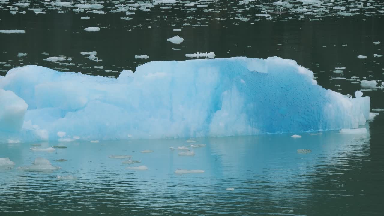 Big iceberg floating at Endicott Arm fjord, Dawes Glacier. Global warming affecting the glaciers of Alaska.