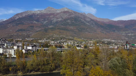 a city of dreams the valle d’aosta, with the amazing mountains and transportation view with heavy trawlers, northern italy, a drone view