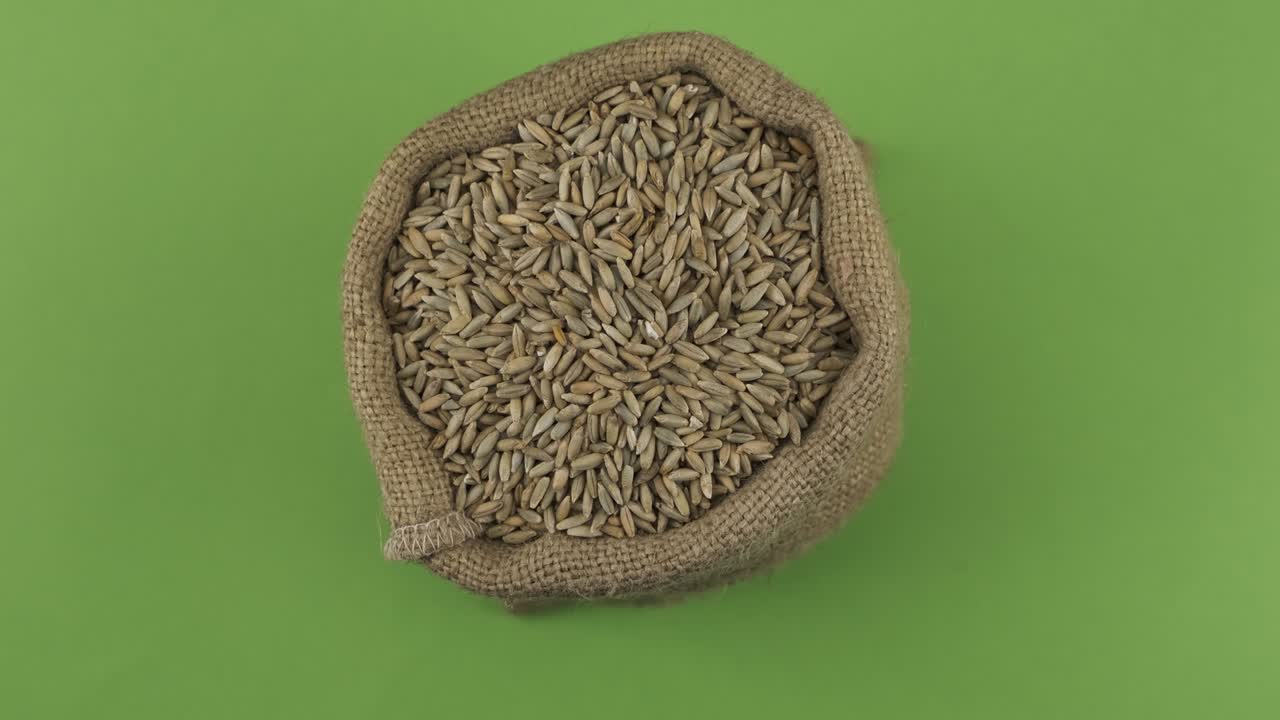 Rotation of a full sack of rye grain. Top view. Isolated