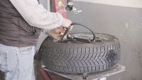 technician car tire inflation with inflator.