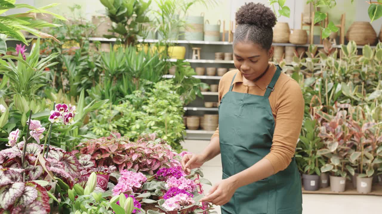 A woman tending to plants in a plant shop