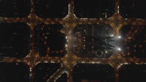 Top-down-panning-footage-of-well-known-tourist-attraction,-unfinished-basilica-Sagrada-Familia-at-night.-Barcelona,-Spain