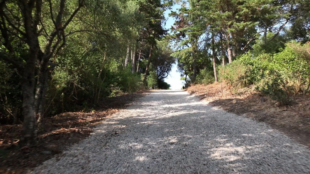 Drone shot flying low on a gravel road.