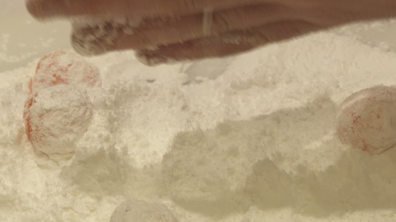 Preparing Orange Candies with Powdered Sugar
