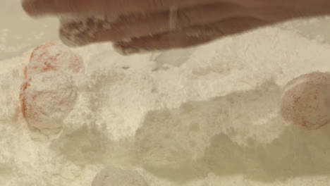 preparing orange candies with powdered sugar