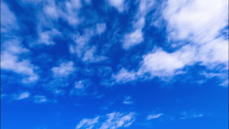 azure sky with floating white light clouds. low angle view on the beautiful summer sky. timelapse.
