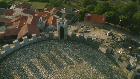 Drone-pans-over-the-tower-ramparts-of-Folgosinho-Castle
