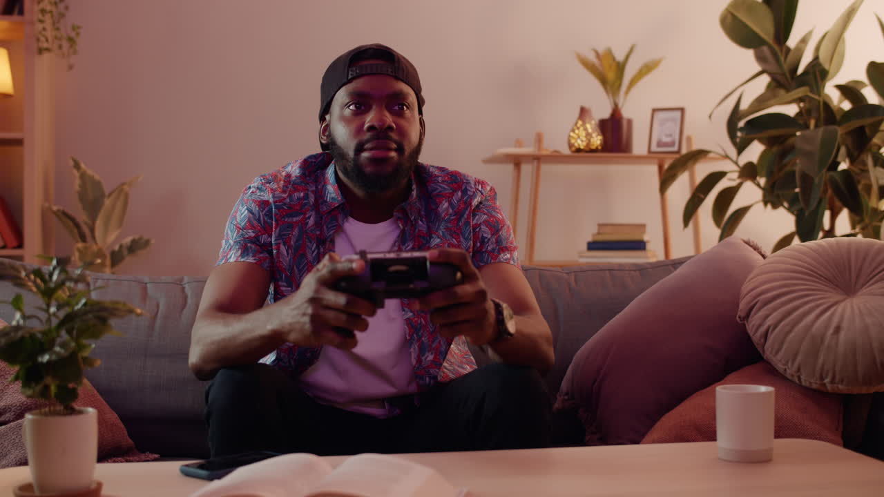 Man playing video games on couch