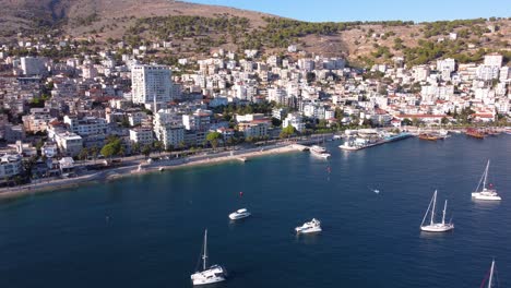 AERIAL-Flying-Backwards-Shot-of-Sarande,-Albania