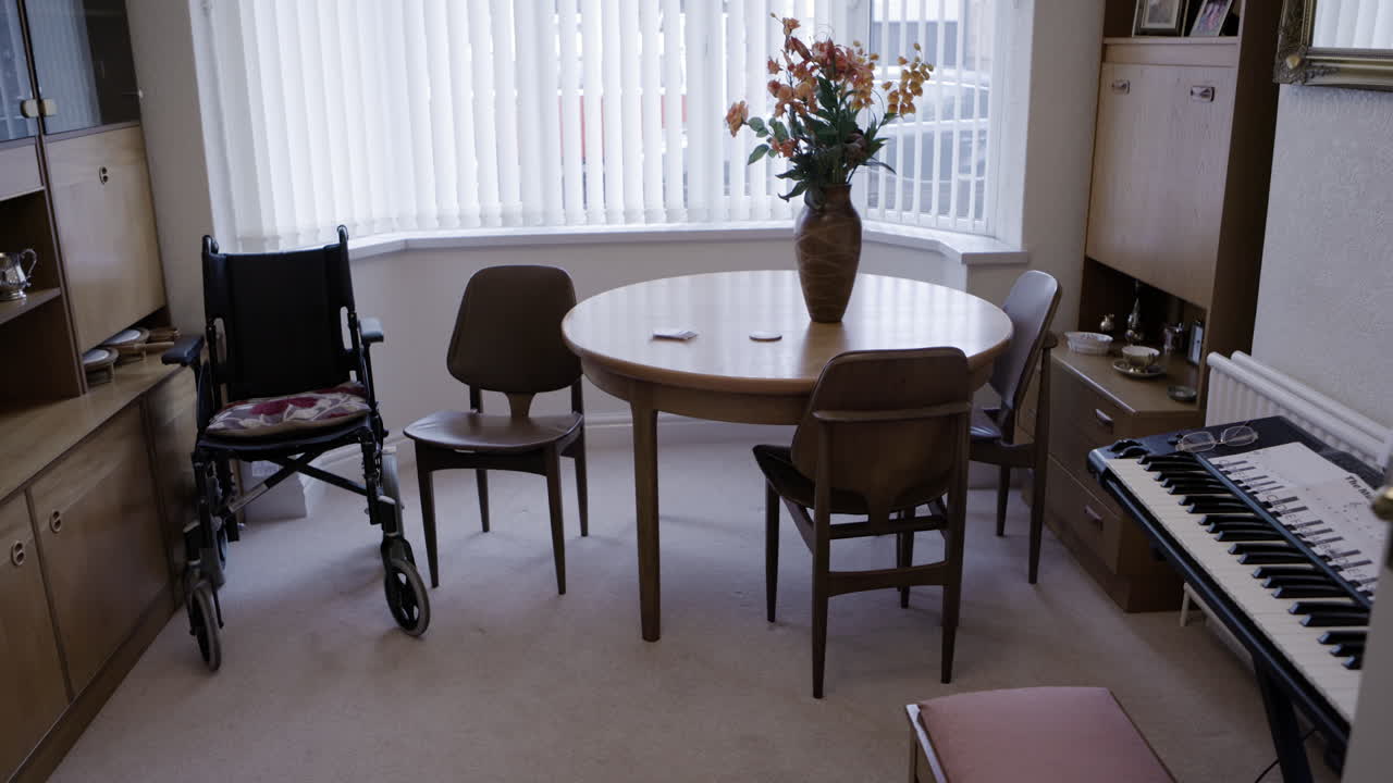 Dining room interior with furniture and wheelchair