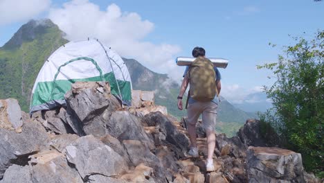 asian hiker male hiking to the top foggy mountain. camping on the mountain