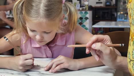 girl drawing with parent