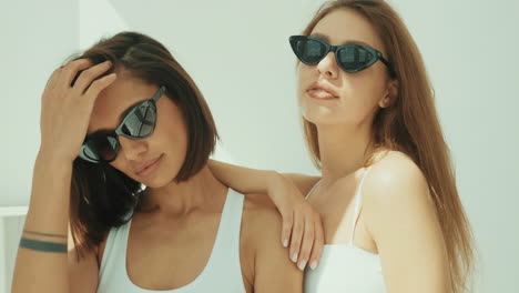 two beautiful women wearing sunglasses