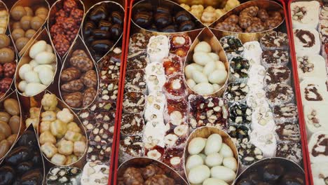 turkish delight, chocolate, and nuts in a colorful display