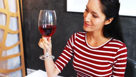 Smiling-mature-woman-drinking-red-wine