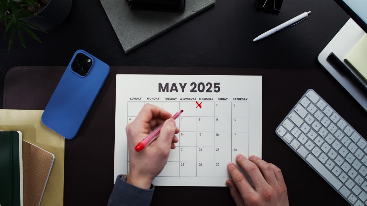 Person planning their schedule in May 2025