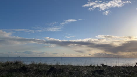 clouds moving past horizon on the coast on olympic peninsula, establishing shot