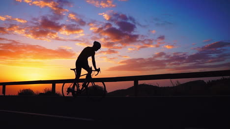 silhouette in slow motion, the athlete cycles on a mountain serpentine, embracing the island's view, symbolizing a dedication to a healthy lifestyle during sunset