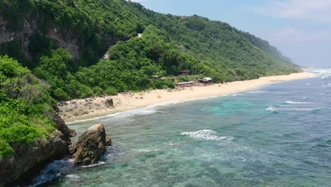 rocky-cliff-coastline-of-Nyang-Nyang-Beach-on-sunny-day-in-Uluwatu-Bali,-aerial