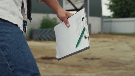 manager walking farming facility. unknown businessman holding clipboard closeup.