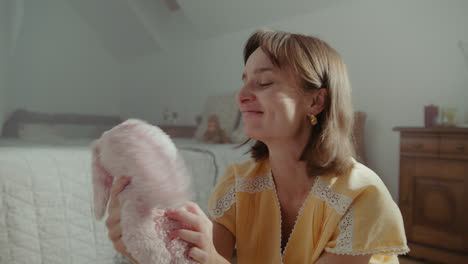 a girl playing with dolls in her room