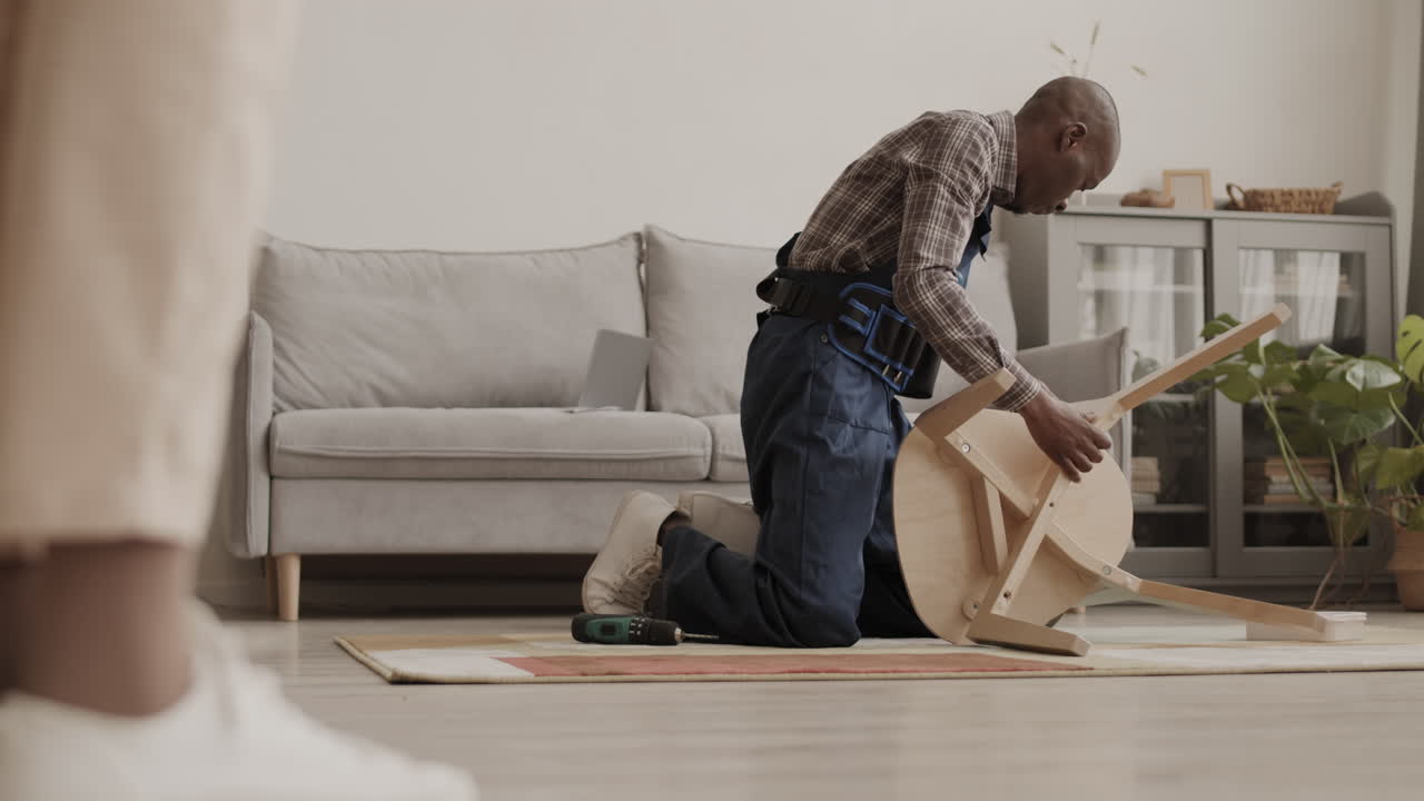 Unrecognizable Woman Watching Carpenter Assembling Chair