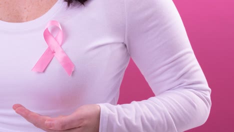 Video-of-midsection-of-caucasian-woman-wearing-pink-cancer-awareness-ribbon