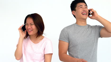 asian couple laughing on phone call