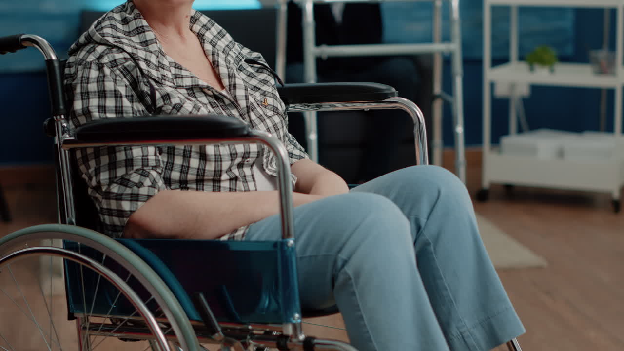 Portrait of old handicapped woman looking at camera