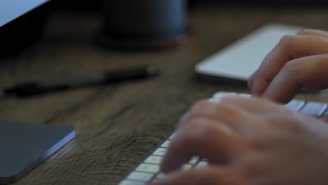 man types on a wireless keyboard close up with copy space