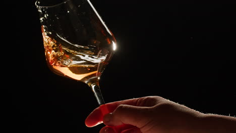 rose orange or white wine bottle and glass against a sunset in a peaceful vineyard, pouring of ecological natural wine. cheers, hands with wine glasses, drinking alcohol.