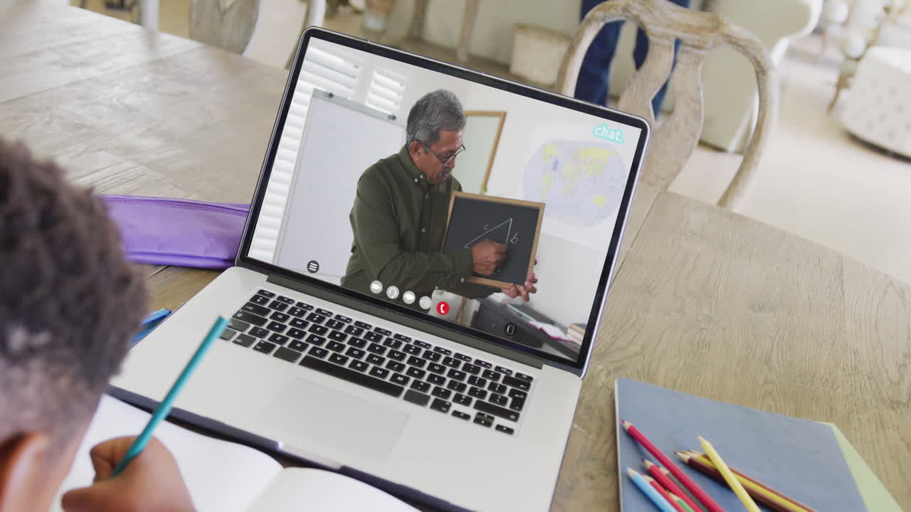 Composition of african american boy on laptop online learning with biracial male teacher
