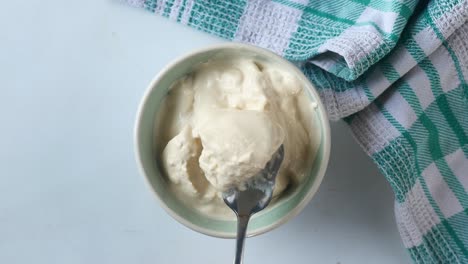 Top-view-of-milk-cream-in-a-container-on-table