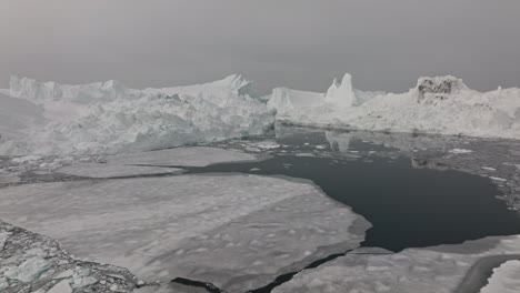 drone over sea and ice of ilulissat icefjord