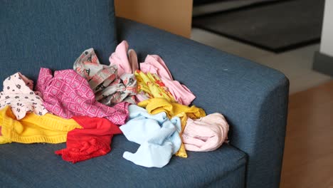 pile of clothes on a sofa