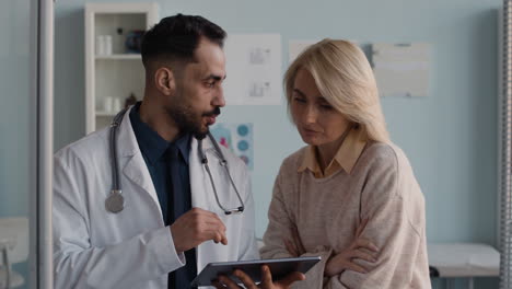 doctor consulting with patient using tablet