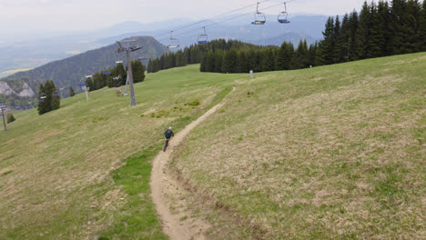 Joven-En-Bicicleta-A-Través-De-La-Ladera-Cubierta-De-Hierba-En-Verano-En-Malino-Brdo-Resort,-Liptov,-Eslovaquia