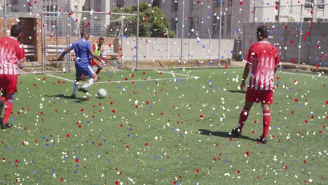 colorful confetti falling against two teams of male soccer players playing soccer on grass turf