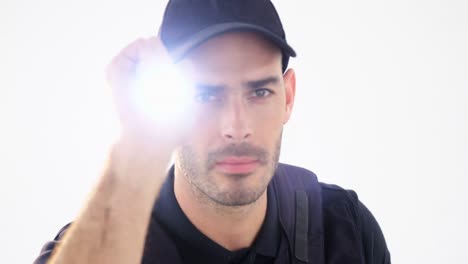 Security-guard-holding-torch-on-white-background