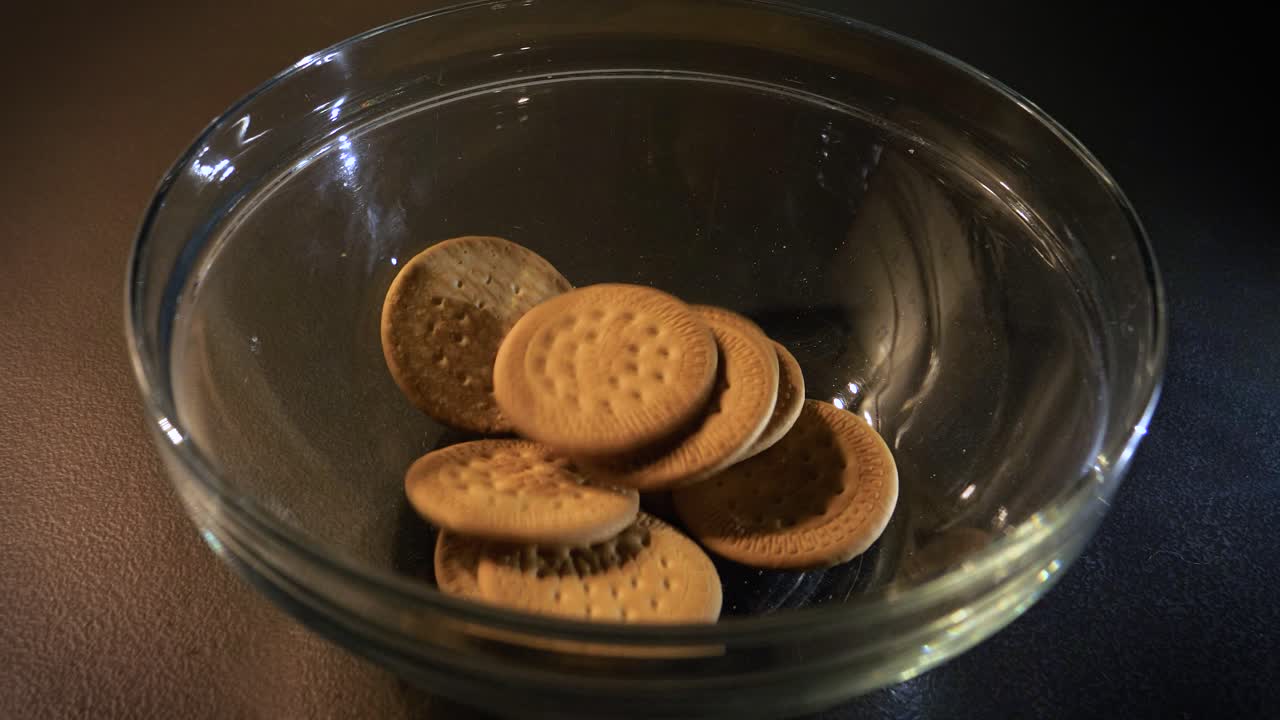 Traditional Portuguese Maria Biscuit filling a Bowl, Dark Background