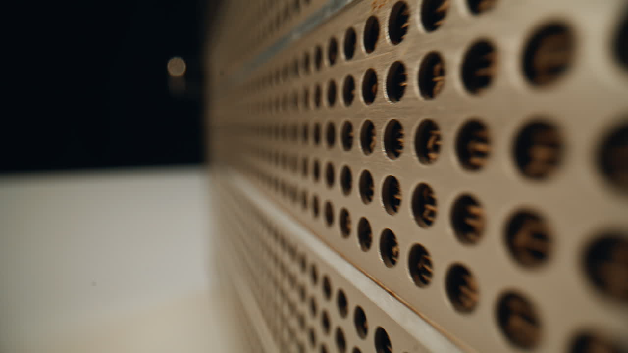 Closeup vintage radio front transmitting audio signal in dark room. Metal panel