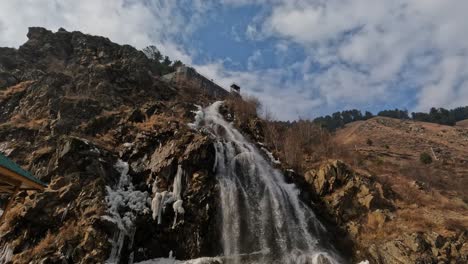 water falls with hill mountain and ice at drung, jammu and kashmir, day time, tilt up shot, 4k.