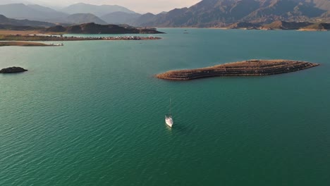 Slow-rotating-aerial-shot-of-an-anchored-sailboat-in-the-tropical-waters-of-Mendoza